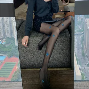 Sheer black pantyhose featuring delicate blue butterfly print, sexy and stylish hosiery design.
