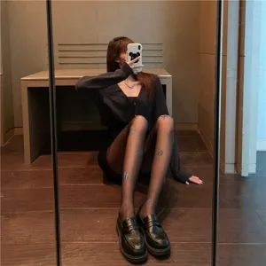 Sheer black tights for women featuring delicate blue butterfly prints, trendy translucent hosiery.