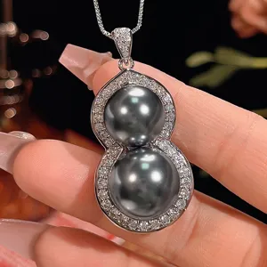 Elegant double pearl gourd pendant necklace featuring sparkling pavé stones in detailed shot.
