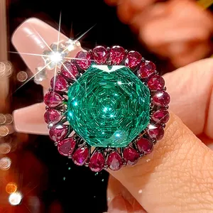 Exquisite copper gold-plated black ring featuring a large green main stone and vibrant ruby halo.