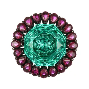 Stunning black gold statement ring featuring a large square green main stone surrounded by pink gems.