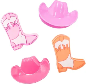 Close-up of cute pink and orange cowboy boot and hat shaped plastic food bag sealing clips.