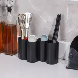 Close-up of a black 4-compartment kitchen utensil holder, perfect for chopsticks and spoons.