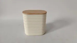 Detailed view of white ribbed plastic storage jar with natural bamboo lid for home organization.