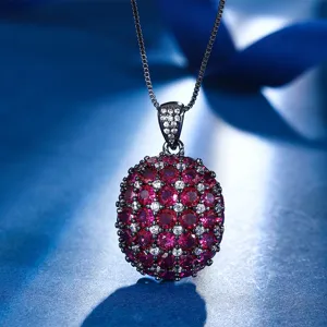 Exquisite pave red synthetic ruby sphere pendant necklace with black gold plating.
