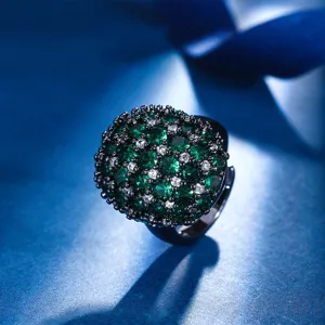 Close-up detail of the luxury black gold plated dome ring featuring dense green and white crystal cluster.