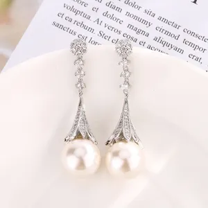 Detailed view of elegant long pearl tassel earrings sparkling zircon stone drops jewelry piece.