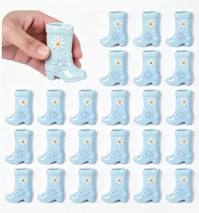 Miniature cute daisy flower rain boot shaped ceramic cup or small vase desktop ornament detail.