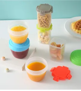 Close-up of portable mini snack and jam storage containers with colorful lids for kids.