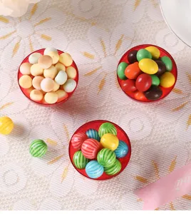 Detail view of creative plastic candy gift boxes filled with colorful candies for wedding.