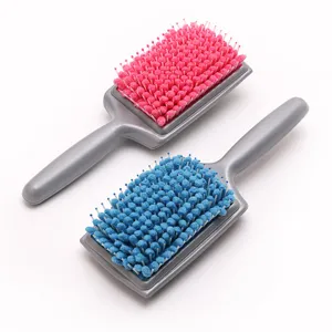 Detail view of quick drying hair brush with sponge teeth and ergonomic handle for comfortable use.