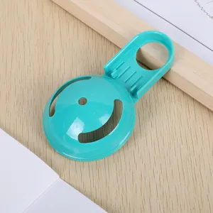 Plastic egg white separator detail shot, kitchen baking tool with blue green filter slot.