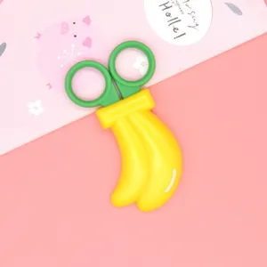 Cute banana children safety scissors detail view, creative stationery for school craft projects.
