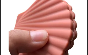 Silicone shell shape kitchen gadget detail view, soft and flexible anti-scald clip feature.