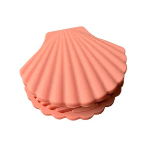Pink silicone shell shaped pot handle cover, creative anti scald kitchen dish clip main view.