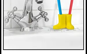 Rain boot toothbrush holder detail, yellow mini rainboot design for bathroom sink storage.