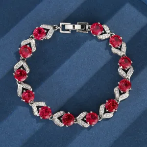 Splendido bracciale tennis vintage in argento con luminosi rubini rossi simulati e cristalli.
