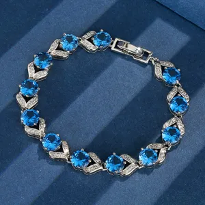 Primo piano dettaglio del bracciale argentato vintage con pietre blu rotonde e cristalli.