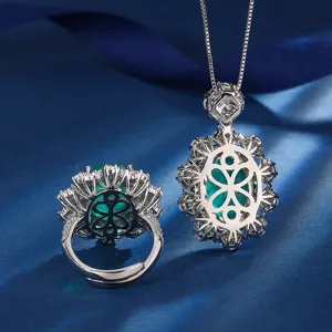 Luxury green gemstone pendant and ring set with sparkling cubic zirconia and classic clover design.
