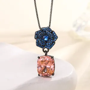 Elegant black gold camellia pendant necklace with blue crystal pave and pink cushion stone.