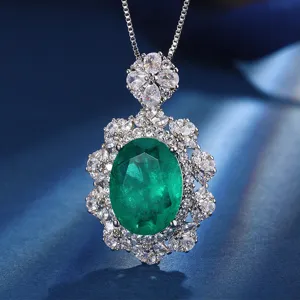 Detail of luxury oval green simulated gemstone pendant necklace featuring sparkling cubic zirconia halo.