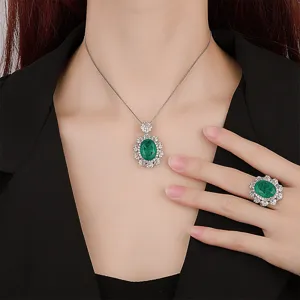 Detailed shot of oval green gemstone pendant and matching ring set with sparkling crystal cluster.