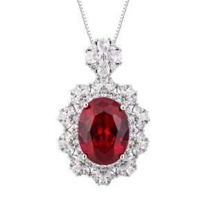 Elegant oval red gemstone halo pendant necklace with sparkling cubic zirconia cluster design.
