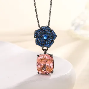 Retro black gold camellia necklace with blue crystal pavé and pink cushion stone pendant.