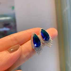 Elegant pear-shaped blue gemstone earrings with sparkling cubic zirconia, stylish jewelry accessory.