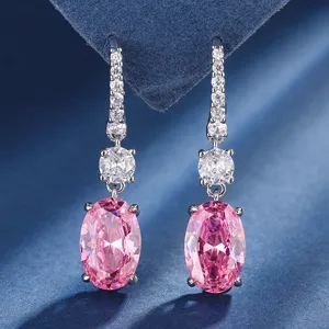 Detailed shot of elegant silver-tone dangle earrings with sparkling pink oval cz stones.