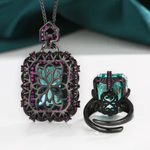 Exquisite black gold jewelry set with radiant cut green gemstone pendant and matching ring.
