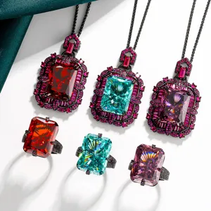Detailed view of luxury radiant cut colored gemstone necklace and ring set in black gold.
