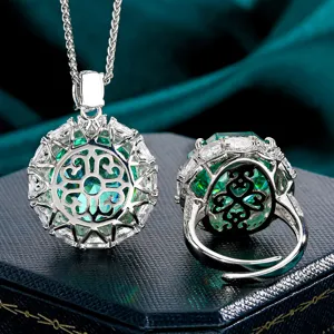 Detailed shot of exquisite green gemstone necklace and ring set with elegant hollow design.