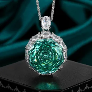 Close-up detail of luxury green rose-cut gemstone necklace with sparkling zircon halo pendant.