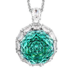 Detailed shot of the rose-cut green gemstone pendant necklace with white crystals.