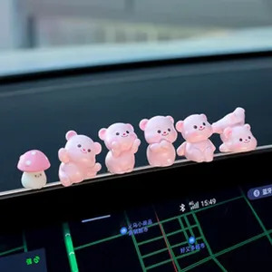 Close-up of cute pink bear and mushroom car dashboard ornaments set, displayed on AC vent.