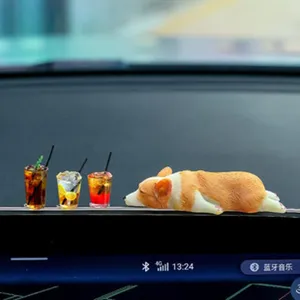 Cute sleeping Corgi car dashboard ornament with miniature drink cups, detailed close-up shot.