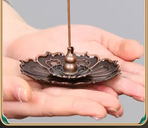 Close-up detail of the vintage bronze lotus incense burner, featuring a central gourd holder.