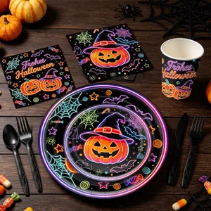 Neon Halloween party tableware set detail with pumpkin and spider web prints on plates and cups.