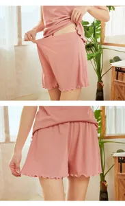 Women summer ribbed lounge set in pink with tank top and shorts featuring cute lettuce hem.