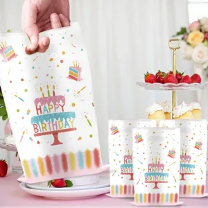 Detailed view of birthday party gift bag with colorful cake print and confetti design.