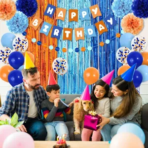 Blue and orange birthday party decoration set with hanging banner, pom-poms, and balloons.