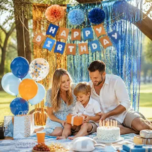 Detailed scene showing blue and orange birthday party decorations, paper pom poms and banner.