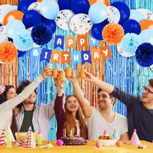 Blue and orange birthday party decoration set with banner balloons and paper pom poms