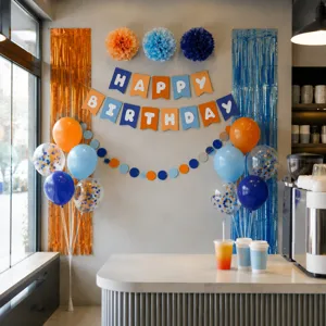 Blue and orange birthday party decoration set with happy birthday banner and balloons.