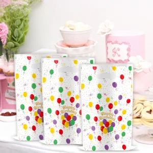 Birthday party goody bags detail, colorful balloon plastic gift bags with handles.