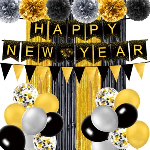 Black and gold New Year party decoration details, featuring banner flags and balloons.