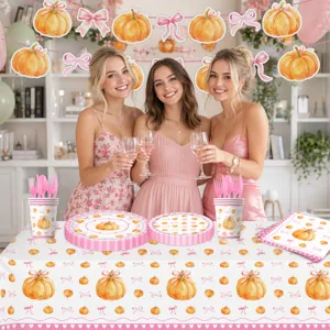 Juego de vajilla para fiesta de calabaza con lazo, platos de papel, vasos y mantel.