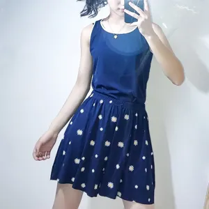 Blue sleeveless top and daisy print skirt set, comfortable ribbed cotton fabric for summer loungewear.
