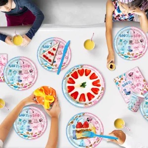 Gender reveal party tableware table setting details with themed paper plates and cups.